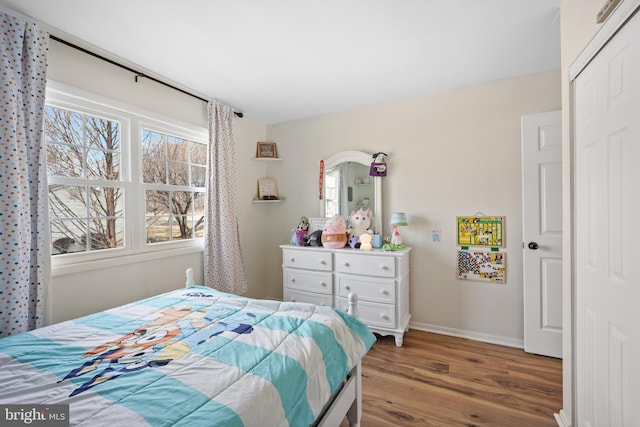 bedroom with wood finished floors and baseboards