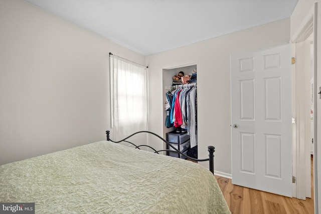 bedroom featuring light wood-type flooring and a closet