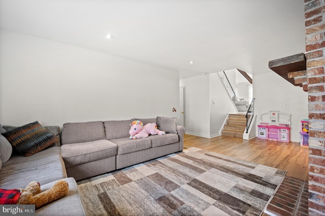 living room with recessed lighting, stairway, baseboards, and wood finished floors