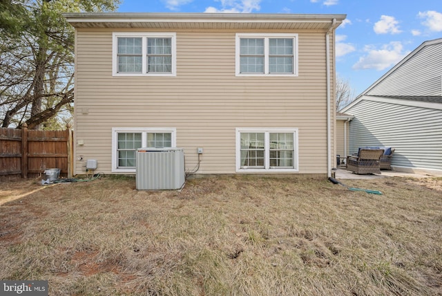 back of property featuring cooling unit, a lawn, a patio area, and fence