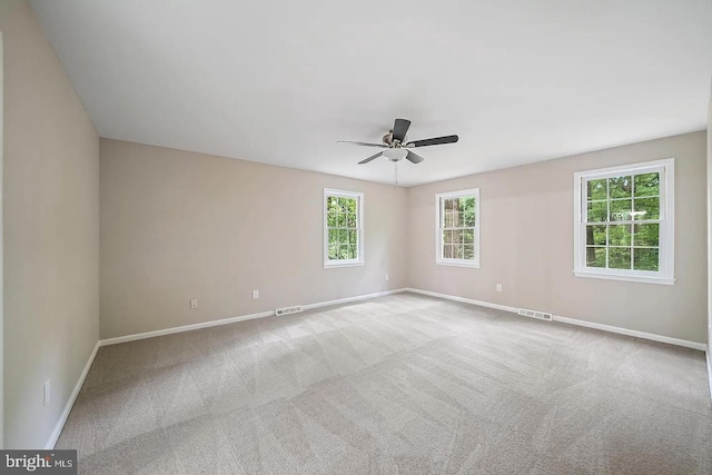 empty room featuring visible vents, baseboards, carpet, and ceiling fan