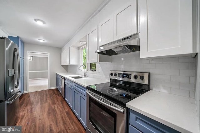 kitchen featuring blue cabinets, appliances with stainless steel finishes, under cabinet range hood, and a sink