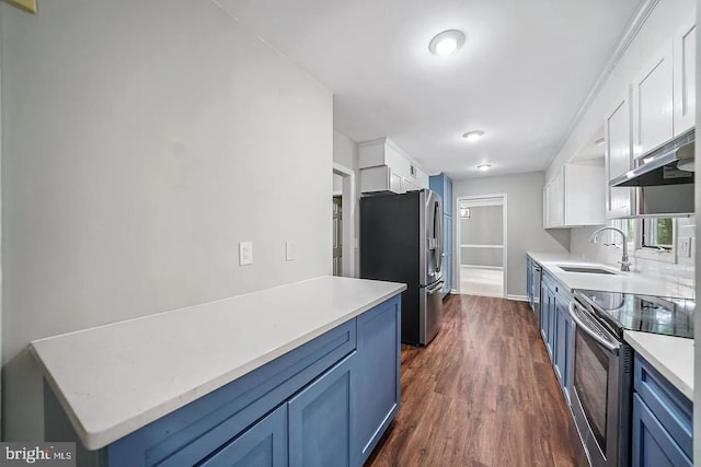 kitchen with a sink, under cabinet range hood, white cabinetry, stainless steel appliances, and light countertops