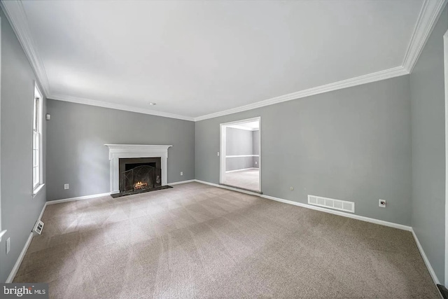 unfurnished living room featuring carpet flooring, baseboards, visible vents, and a lit fireplace