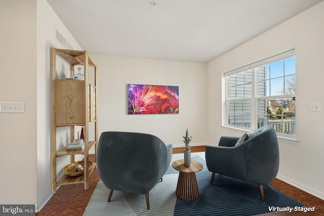 sitting room featuring visible vents, baseboards, and wood finished floors