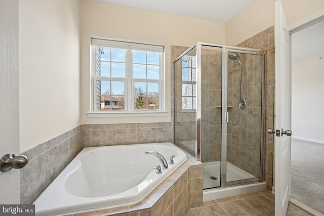 full bathroom with a bath, a shower stall, and tile patterned floors