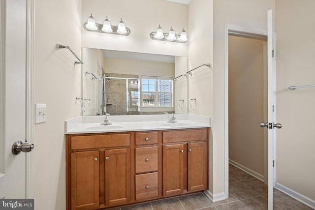 full bathroom with a sink, tile patterned flooring, double vanity, and a tile shower