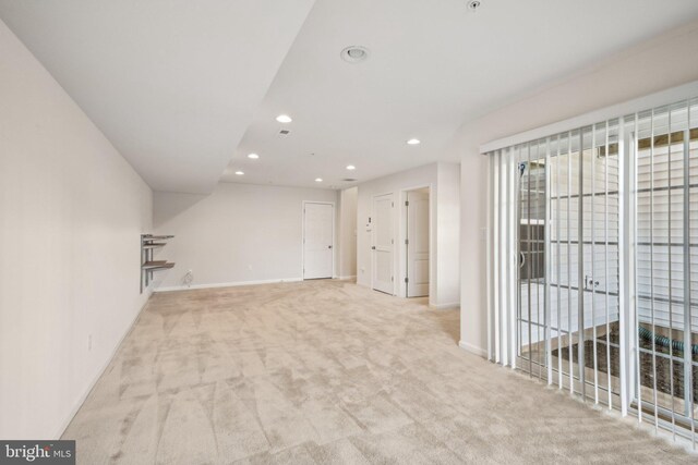 empty room with carpet flooring, recessed lighting, and baseboards