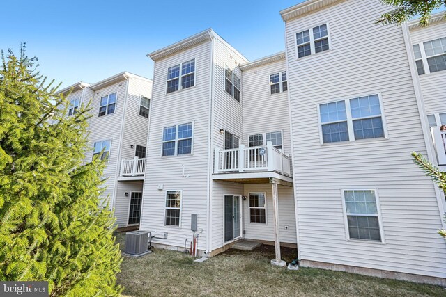 rear view of property featuring central AC unit