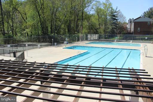 pool featuring a patio and fence