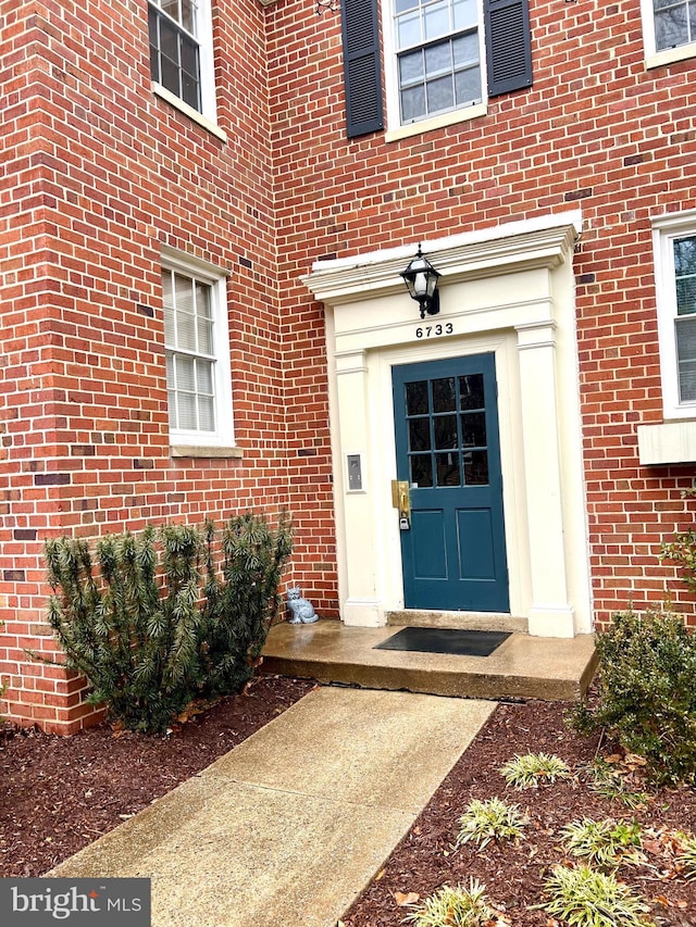 entrance to property with brick siding