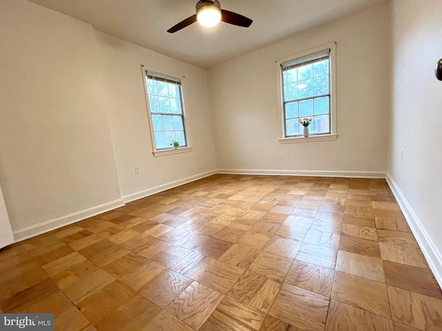 empty room featuring baseboards and a ceiling fan