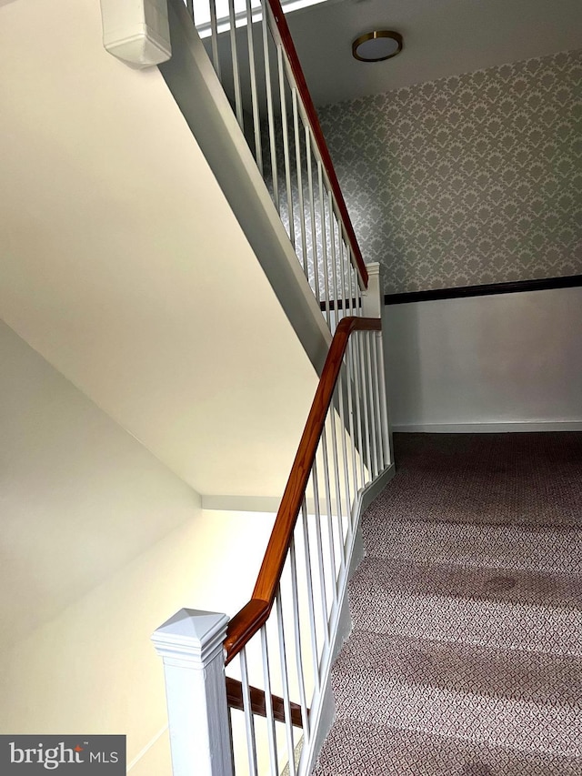 staircase featuring carpet flooring, wainscoting, wallpapered walls, and baseboards