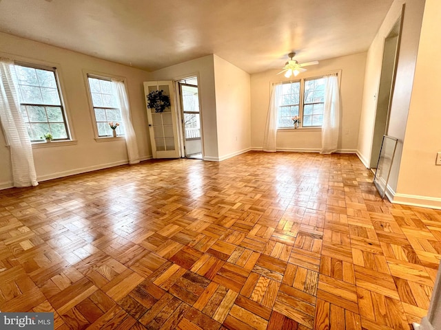 empty room featuring baseboards and a ceiling fan