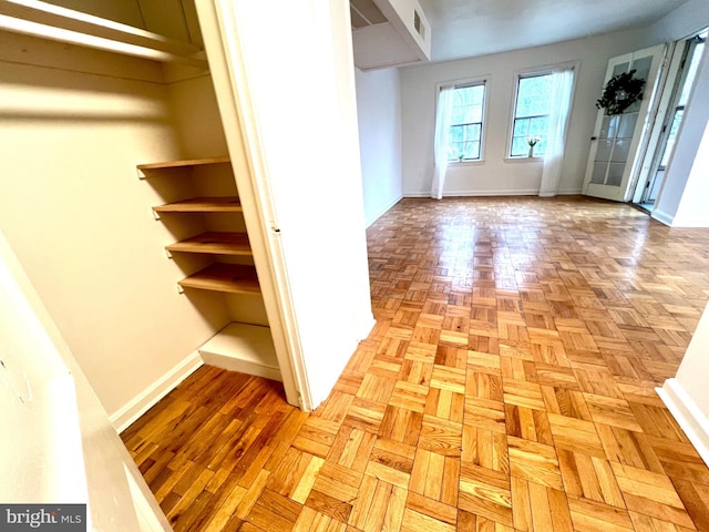 interior space with baseboards and visible vents