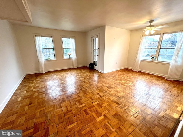 spare room featuring baseboards and ceiling fan