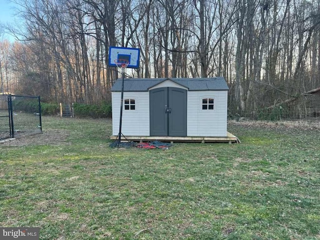 view of shed featuring fence