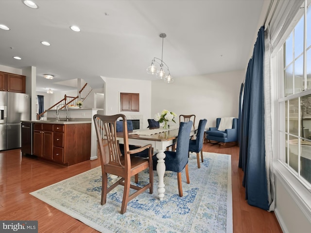 dining room featuring recessed lighting, stairway, and wood finished floors