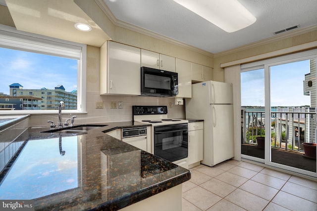 415 14th St Unit 55A, Ocean City, MD 21842 - kitchen with black microwave, range with electric stovetop, a sink, freestanding refrigerator, and ornamental molding
