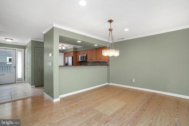 415 14th St Unit 55A, Ocean City, MD 21842 - kitchen featuring stainless steel appliances, brown cabinetry, baseboards, light wood finished floors, and ornamental molding