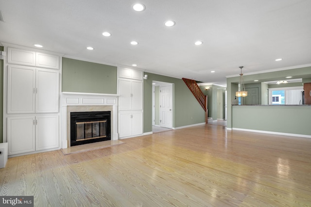 415 14th St Unit 55A, Ocean City, MD 21842 - unfurnished living room featuring ornamental molding, recessed lighting, a fireplace, light wood-type flooring, and a chandelier