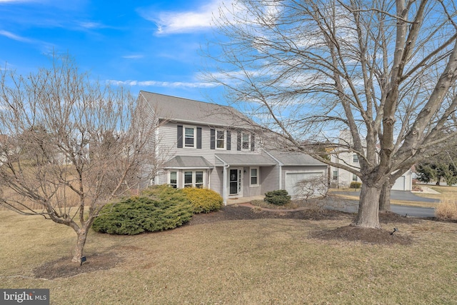 view of front of home with a front lawn, an attached garage, and a shingled roof