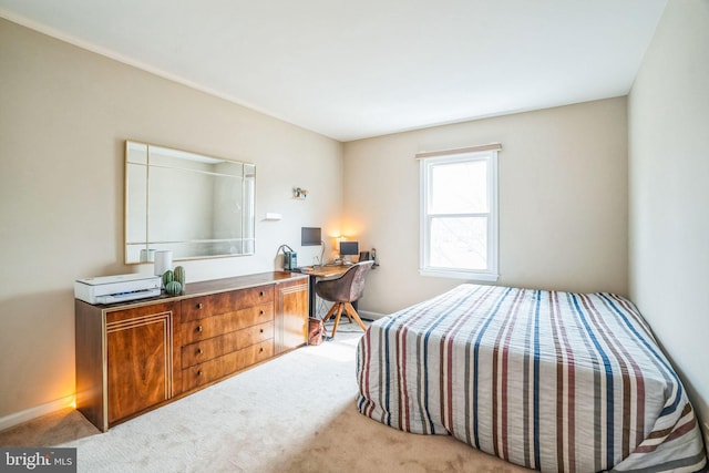 bedroom featuring light colored carpet and baseboards