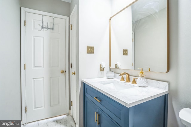 bathroom featuring marble finish floor and vanity