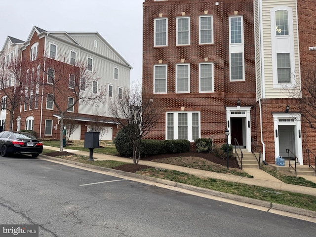 view of property featuring brick siding