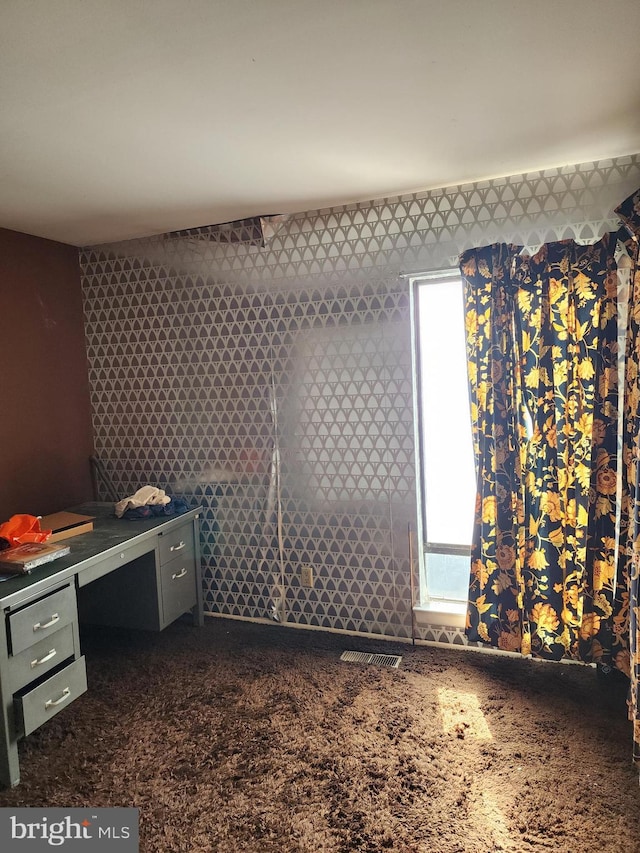 unfurnished bedroom with wallpapered walls