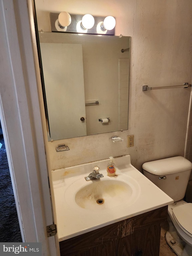 bathroom featuring toilet and vanity