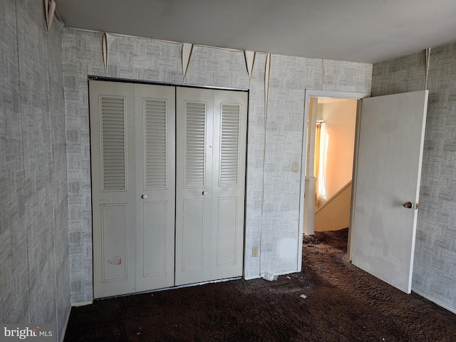 unfurnished bedroom with a closet and carpet