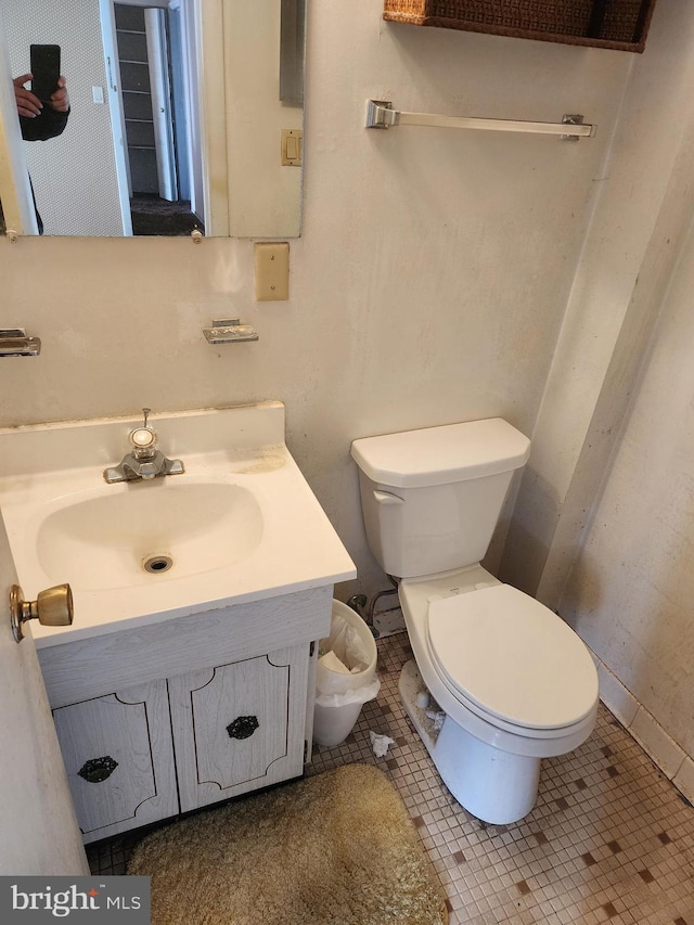 bathroom featuring tile patterned floors, toilet, and vanity