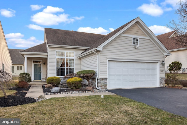 view of front of house featuring aphalt driveway, stone siding, a shingled roof, and a garage