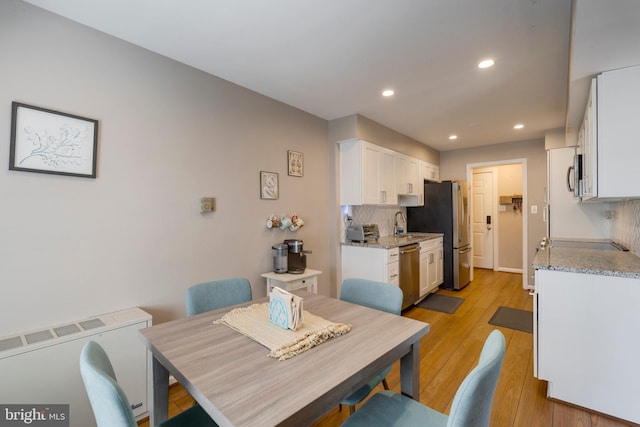 dining space featuring a toaster, recessed lighting, and light wood-style floors