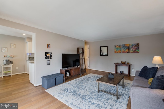 living room featuring light wood-type flooring and baseboards