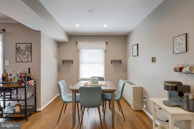 dining room with recessed lighting, baseboards, and light wood-style floors