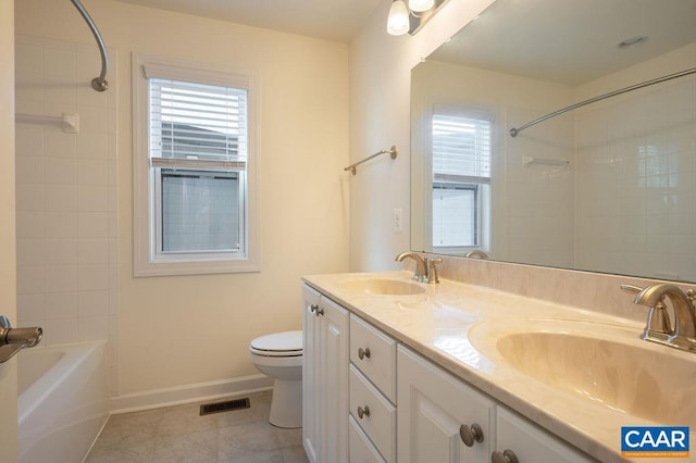 bathroom with plenty of natural light, toilet, visible vents, and a sink