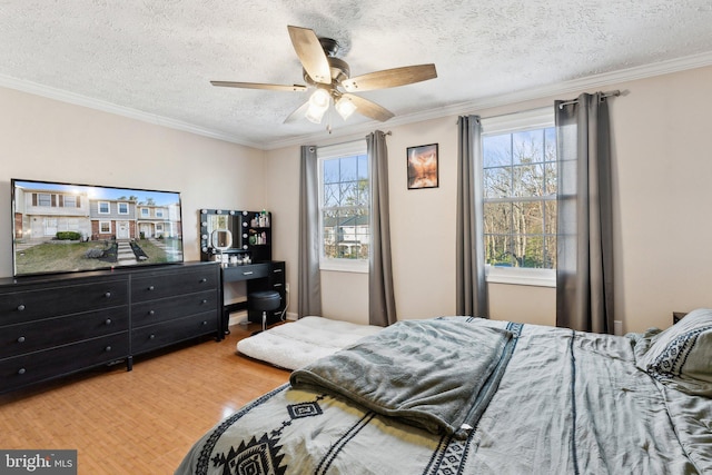 bedroom with a textured ceiling, wood finished floors, and crown molding