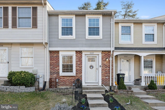 view of property featuring brick siding