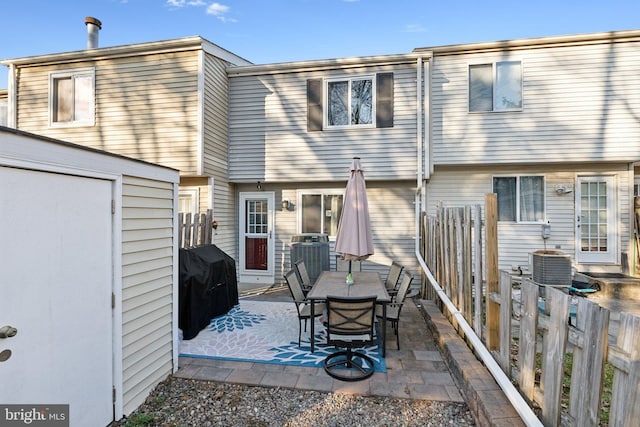 rear view of house with a patio, fence, a shed, central AC, and an outdoor structure