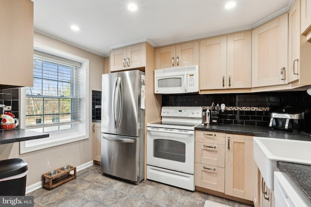 kitchen featuring white appliances, dark countertops, and tasteful backsplash