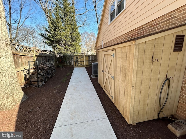 view of yard with central AC unit and a fenced backyard