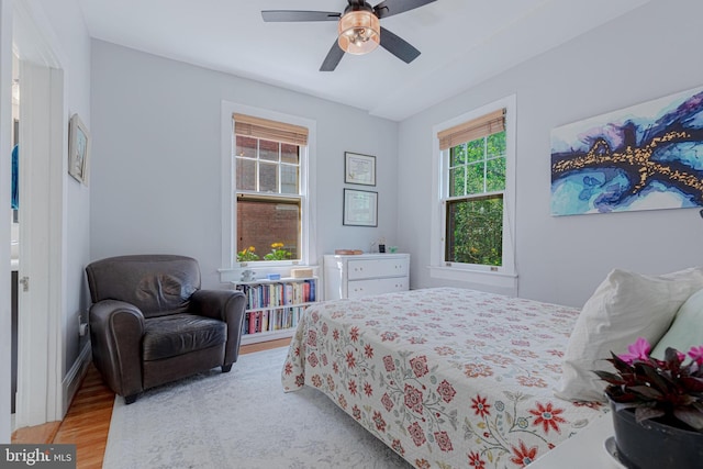 bedroom with light wood-style floors and ceiling fan