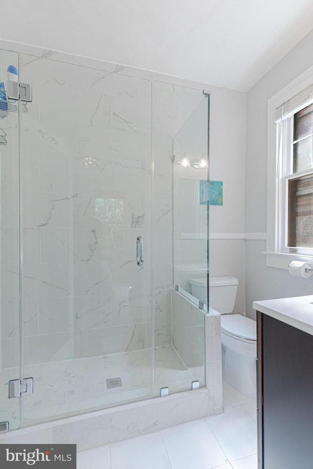 full bath featuring a marble finish shower, toilet, and vanity