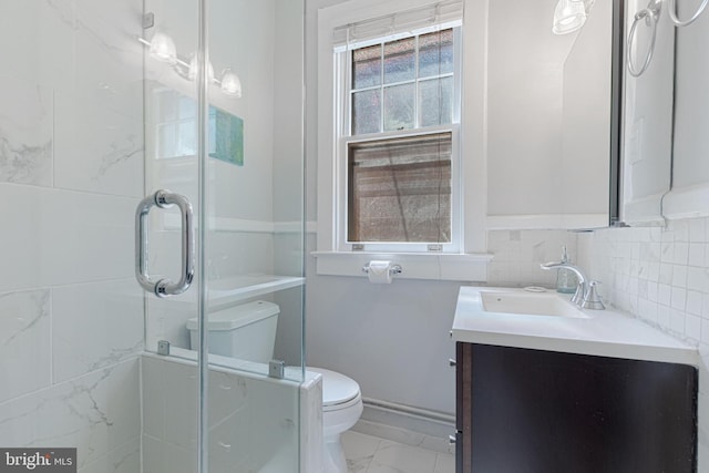 bathroom with a shower stall, toilet, decorative backsplash, marble finish floor, and vanity