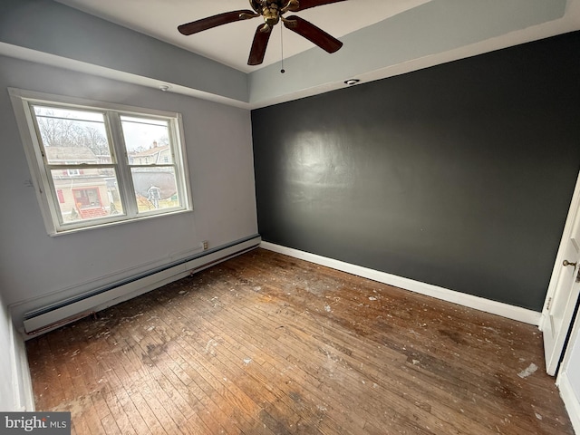 unfurnished room featuring hardwood / wood-style flooring, a ceiling fan, baseboards, and baseboard heating