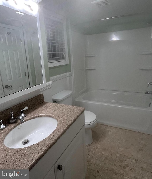 bathroom featuring visible vents, shower / washtub combination, toilet, and vanity