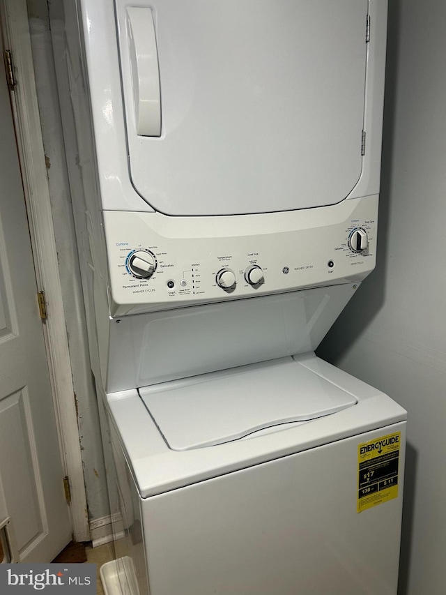 laundry area with laundry area and stacked washer / drying machine