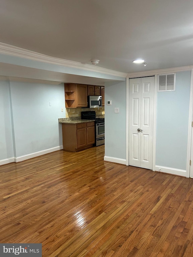 kitchen featuring dark wood finished floors, visible vents, stainless steel appliances, and open shelves